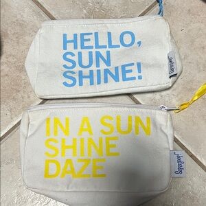 Supergoop! White Cosmetic Bags with Blue and Yellow Text